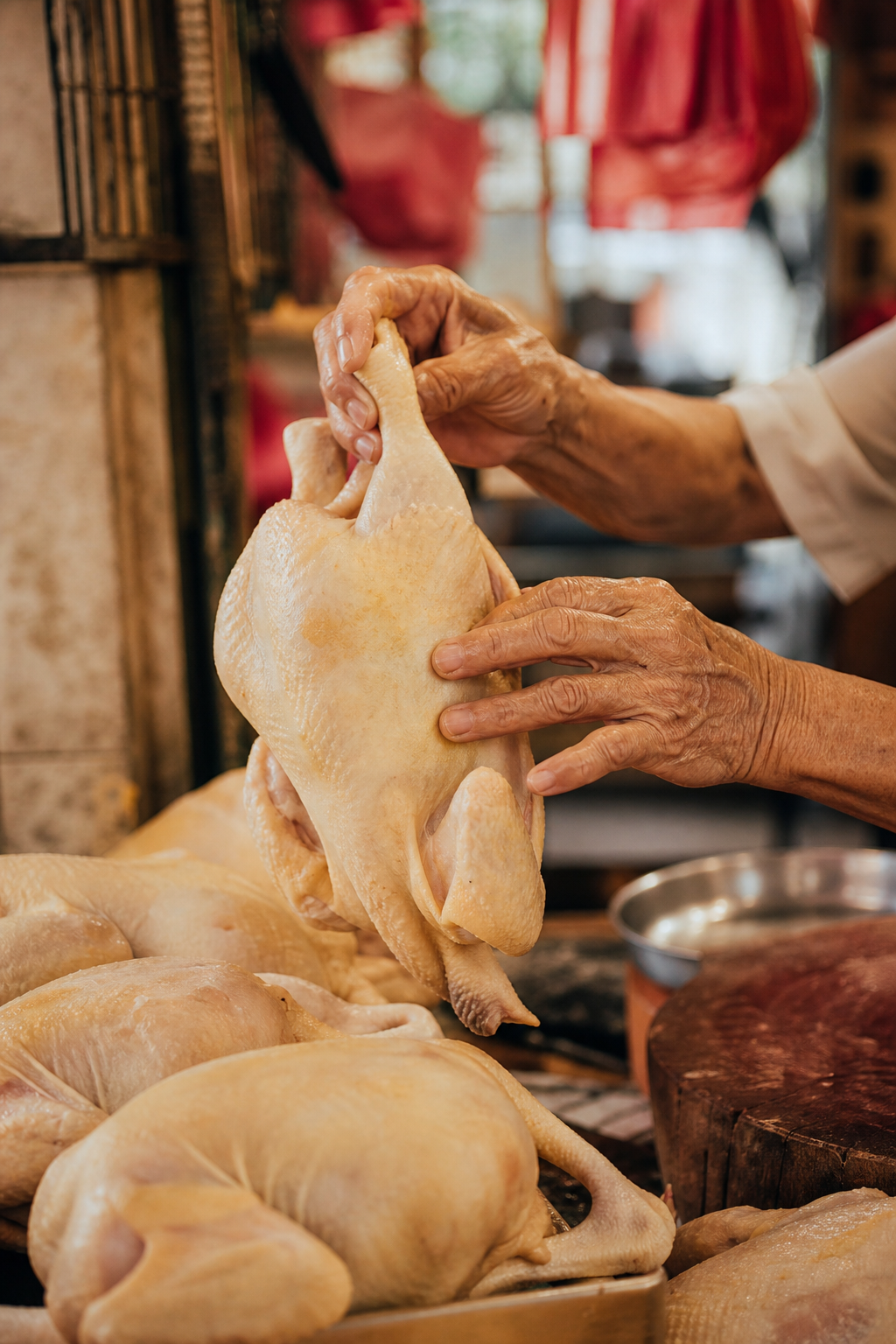 Ah Ma hand-selecting fresh chicken at the wet market